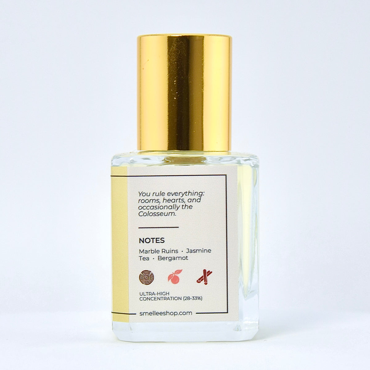 Perfume bottle with gold cap and white label on a light gray background