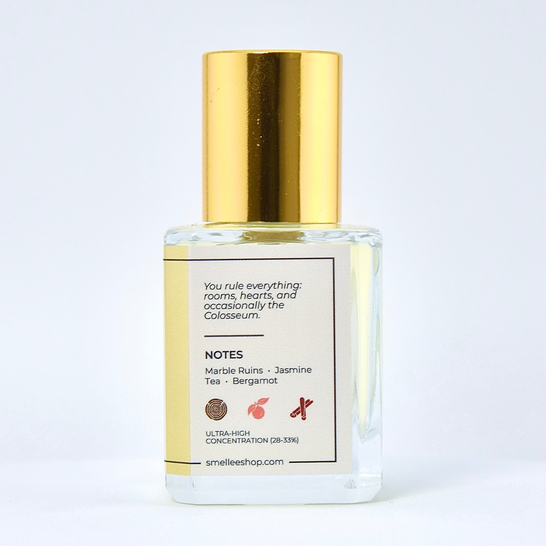 Perfume bottle with gold cap and white label on a light gray background