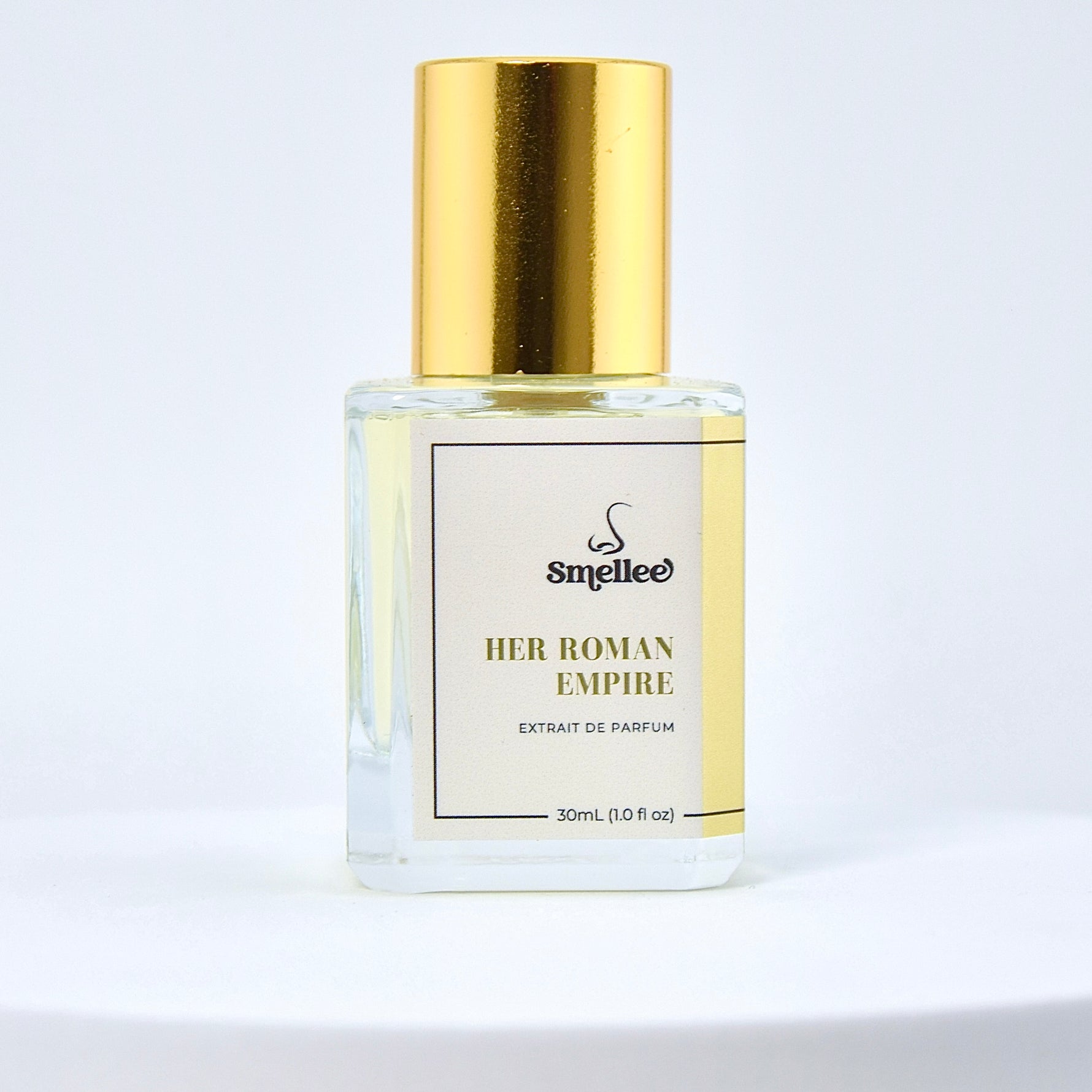 Perfume bottle labeled 'Her Roman Empire' with gold cap on a light gray background