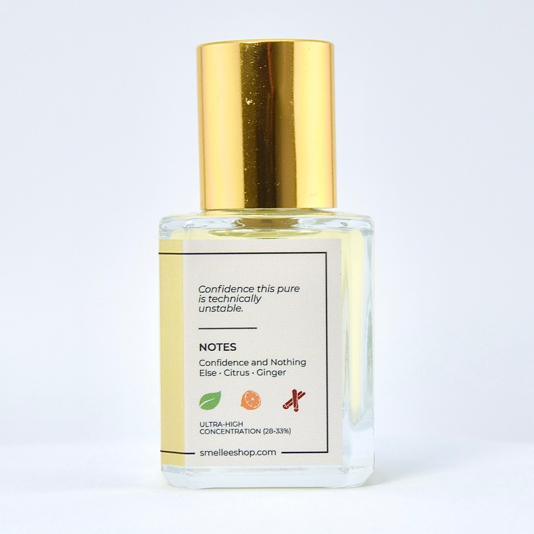 Perfume bottle with gold cap and white label on a light gray background